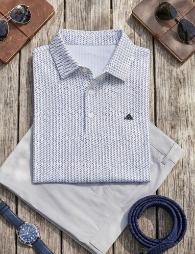 White pattern custom golf polo flatlay — corporate golf apparel