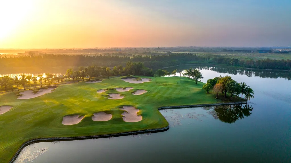 Vattanac Golf Resort aerial — island green at sunrise, Cambodia golf tours