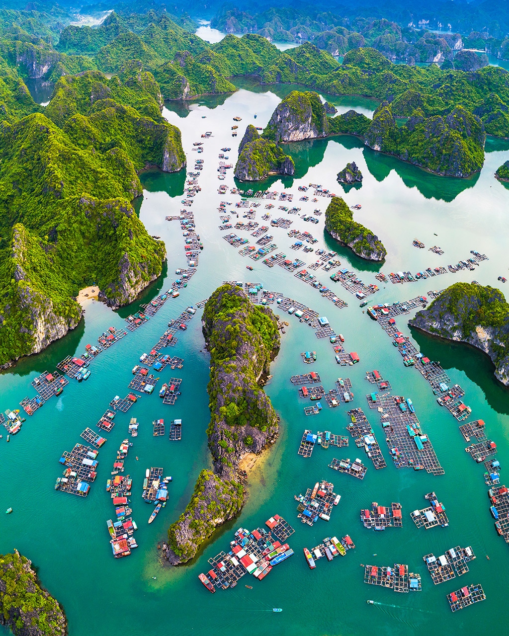 Lan Ha Bay aerial — limestone karsts and turquoise water, explore Vietnam golf tours